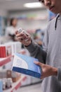 Male client examining sleeping pills box Royalty Free Stock Photo