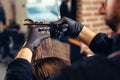 Male client getting haircut by hairdresser. Modern hair salon concept.