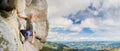 Male climber climbing big boulder in nature with rope