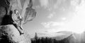 Male climber climbing big boulder in nature with rope Royalty Free Stock Photo