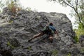 Male climber climbing up a rocky mountain wall and aiming for the top Royalty Free Stock Photo