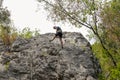 A young sporty man climbing with a rope on the rock. Royalty Free Stock Photo