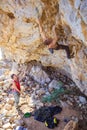 Male climber clipping rope, his partner belaying Royalty Free Stock Photo