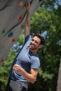 male climber looking happy on climbing wall Royalty Free Stock Photo