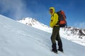 Male climber rises on a snowy volcano.