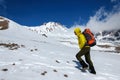 Male climber rises on a snowy volcano.