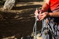 A male climber ties a safety knot eight on the harness before climbing the track. Climbing equipment: rope, quickdraw, safety Royalty Free Stock Photo