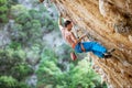 Male climber trying hard to grip small handholds on challenging route Royalty Free Stock Photo