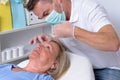 Male Clinician Injecting on Face of a Woman