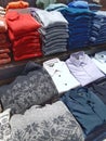 Male cloths of different colours on counter in store.