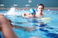 Male Coach In Water Giving Group Of Children Swimming Lesson In Indoor Pool Royalty Free Stock Photo