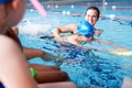 Male Coach In Water Giving Group Of Children Swimming Lesson In Indoor Pool Royalty Free Stock Photo