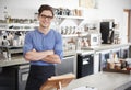 Male coffee shop owner behind the counter, arms crossed Royalty Free Stock Photo