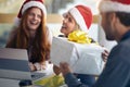 Male colleague gives presents to female coworkers for christmas