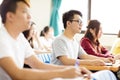 male college student sitting with classmates Royalty Free Stock Photo