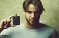 Male cologne. guy with black perfume bottle