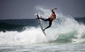 Male surfer jumps a wave