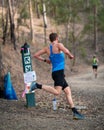 Male competitor running around a corner along a bush trail in the Australian Mountain Running Championships Royalty Free Stock Photo