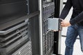 Male Computer Engineer Installing Blade Server In Chassis