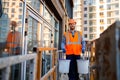 Male construction worker carrying buckets of cement Royalty Free Stock Photo