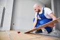 Man installing laminate flooring at home during renovation. Royalty Free Stock Photo