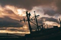 Male construction worker scaling a boat tower at the beautiful sunrise in Umnak, Alaska