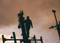 Male construction worker scaling a boat tower at the beautiful sunrise in Umnak, Alaska