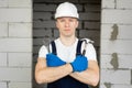 Male construction worker wearing a helmet with a hammer and a wrench. Royalty Free Stock Photo