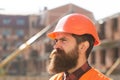 Male construction worker in work clothes and a construction helmet. Industrial theme. Young businessman construction