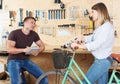 Male is consultating female about bicycle Royalty Free Stock Photo