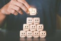 A male consumer chooses a wooden block with a smiley icon. ,Excellent satisfaction rating , Demonstrating satisfactory store