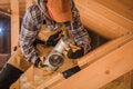 Male Contractor Assembling HVAC Pipes In Attic Of New House