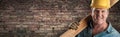 Male Contractor In Hard Hat Holding Wood Plank In Front Of Old Brick Wall Banner with Copy Space