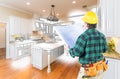 Male Contractor with Hard Hat and Plans in a Custom Kitchen Royalty Free Stock Photo