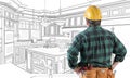 Male Contractor with Hard Hat and Tool Belt Looking At Custom Kitchen Drawing On White. Royalty Free Stock Photo