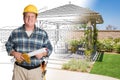 Male Contractor With House Plans Wearing Hard Hat In Front of Structure