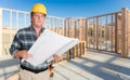 Male Contractor With House Plans Wearing Hard Hat Inside New Home Royalty Free Stock Photo