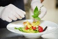 Male cook decorating dish Royalty Free Stock Photo