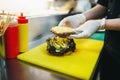 Male cook prepares fast food, burger preparation