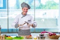 The male cook preparing food in the kitchen Royalty Free Stock Photo