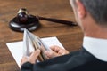 Judge Counting Money In Envelop At Table