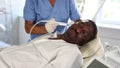 Doctor uses scriber beauty machine nozzle for gentle skin peeling for African-American man client