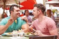 Male Couple Enjoying Lunch In Outdoor Restaurant Royalty Free Stock Photo