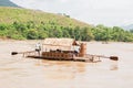 Male couple rafting the bamboo raft house on the Kok River, tropical mountain view riverside. Northern Thailand Royalty Free Stock Photo