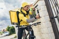 Young man courier with bicycle delivering packages