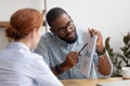 Male coworker showing document with project results to female colleague Royalty Free Stock Photo