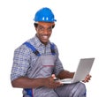 Male craftsman holding laptop