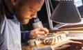 Male craftsman violin maker working on a new violin