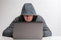 male criminal in the hood hacker spreads the virus