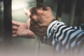 Male criminals was arrested and handcuffed in a dirty cage Royalty Free Stock Photo